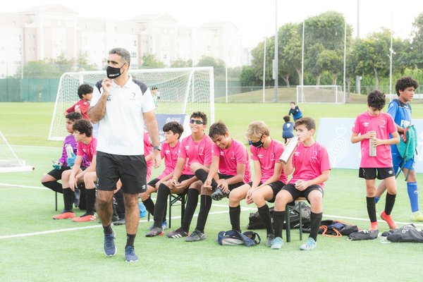 How can young footballers balance school commitments with intensive training?